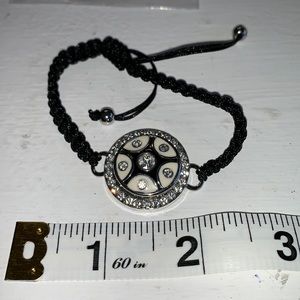 Adjustable braided black cord bracelet with one interchangeable snaps. NWOT